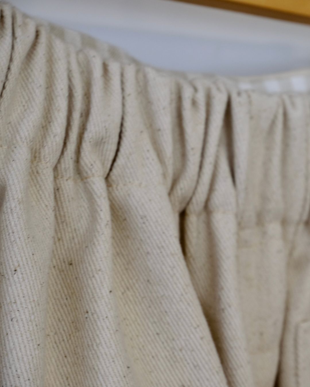 Close-up of beige textured fabric with a blurred background