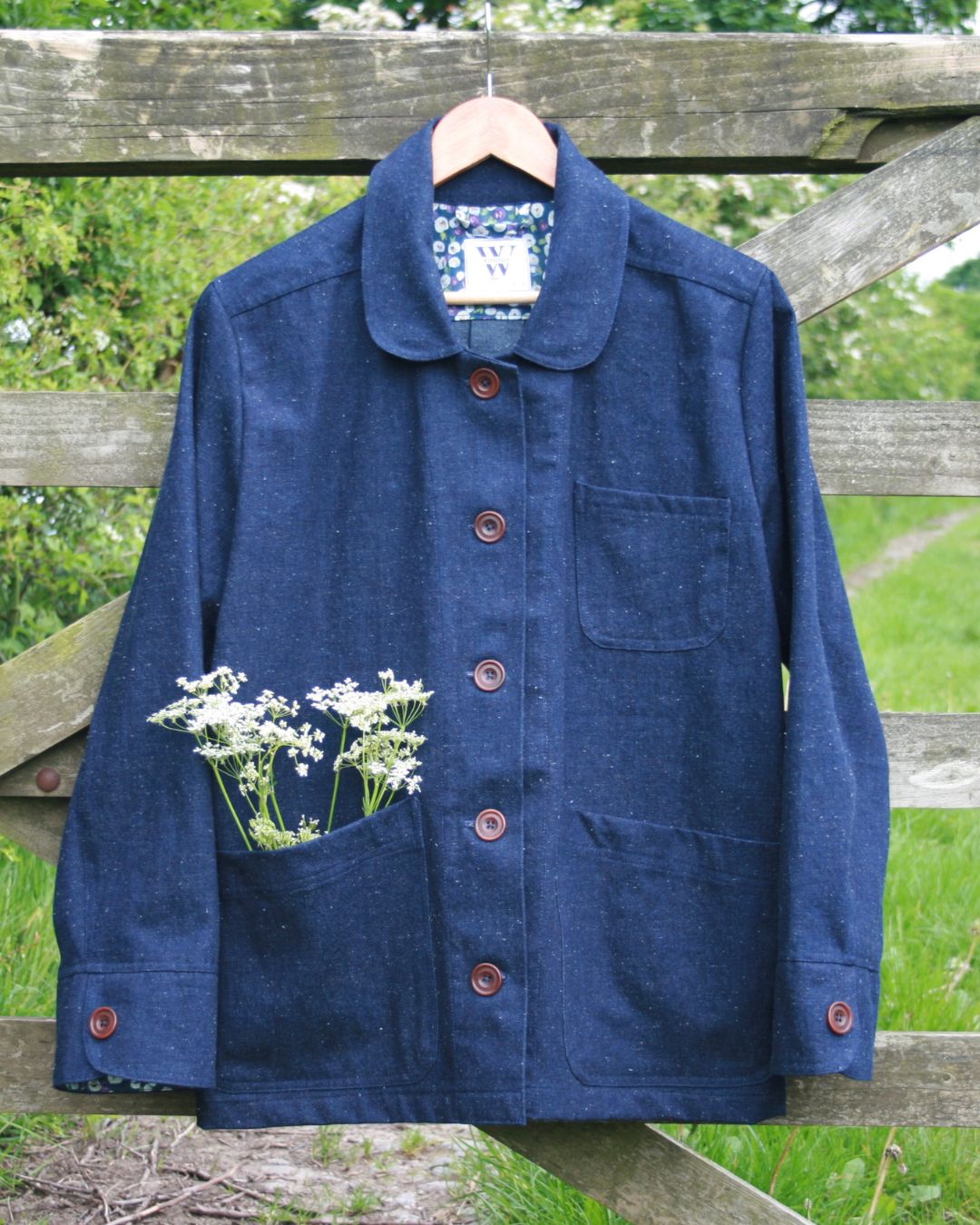 denim jacket hanging from gate.