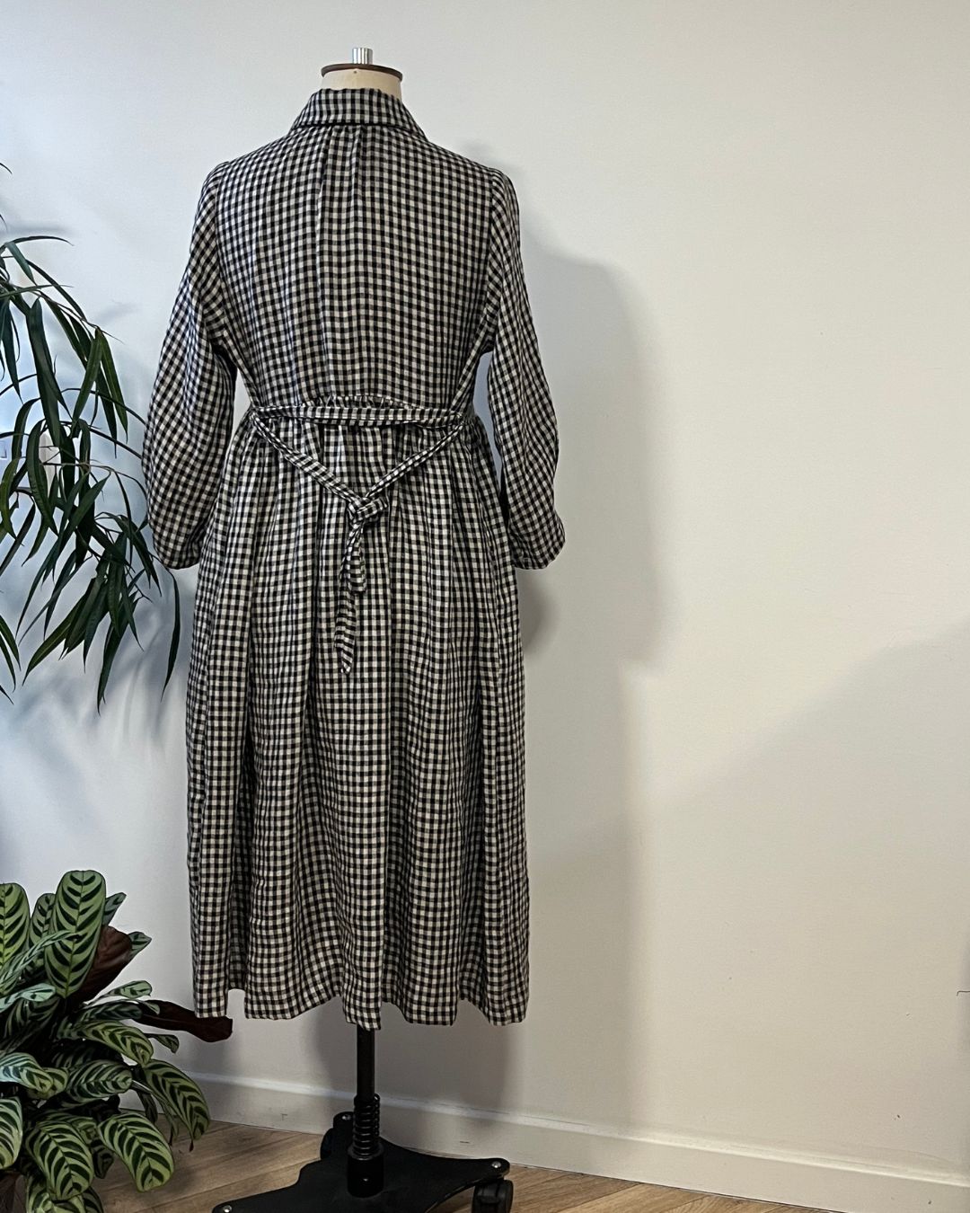 Black and natural check dress on a garment s and with a white background.