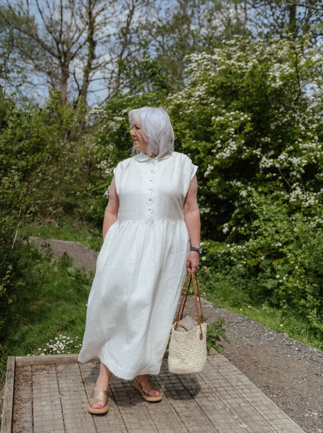 White linen dress with scalloped detail and covered buttons