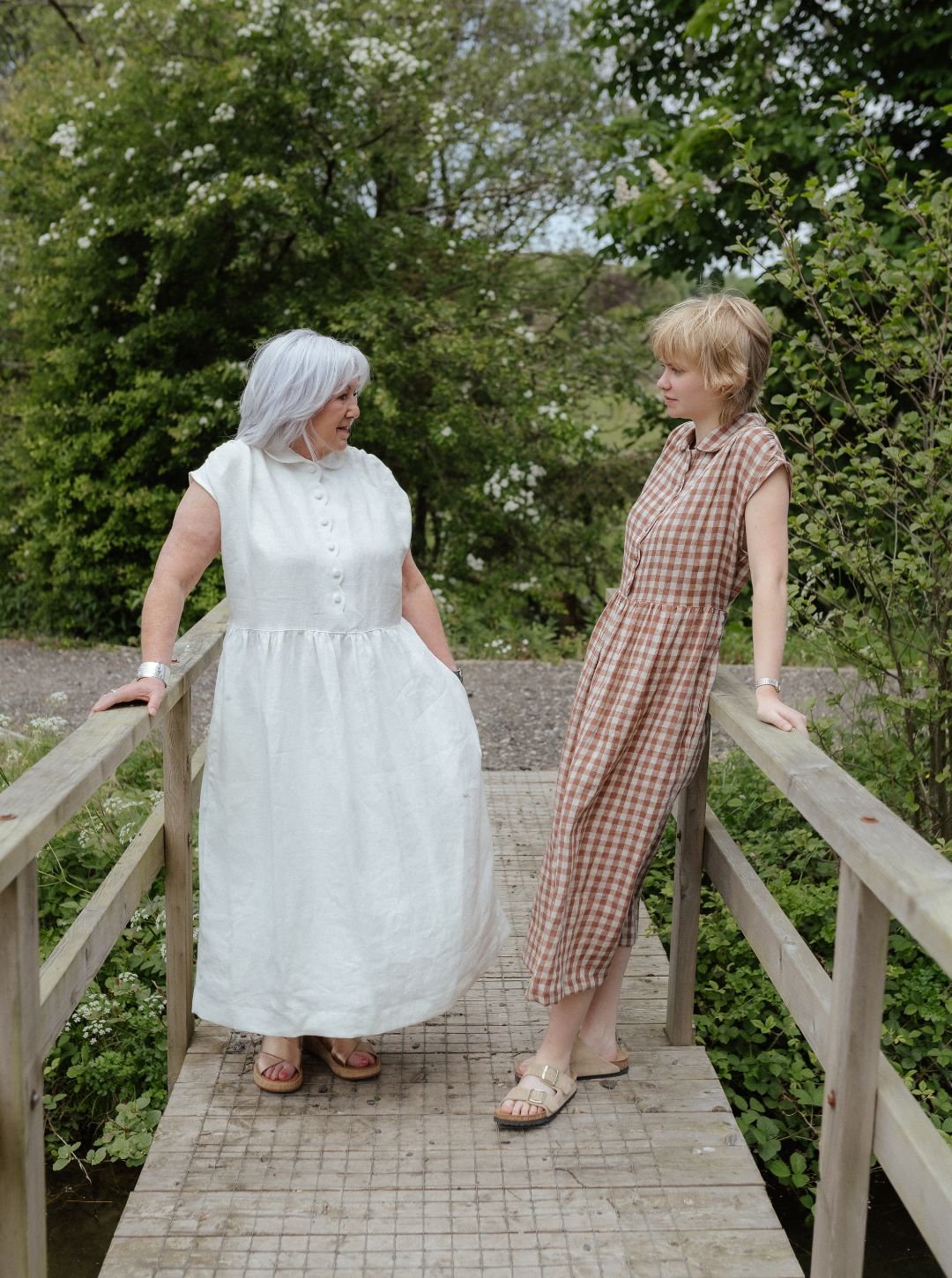 White linen dress with scalloped detail and covered buttons