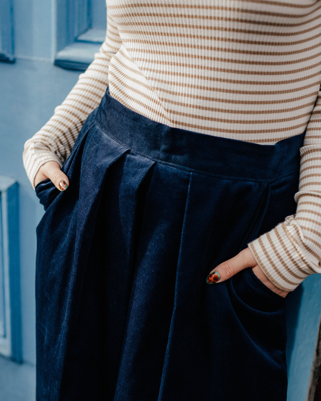 close up detail of cord culottes showing flat waistband and pleats.