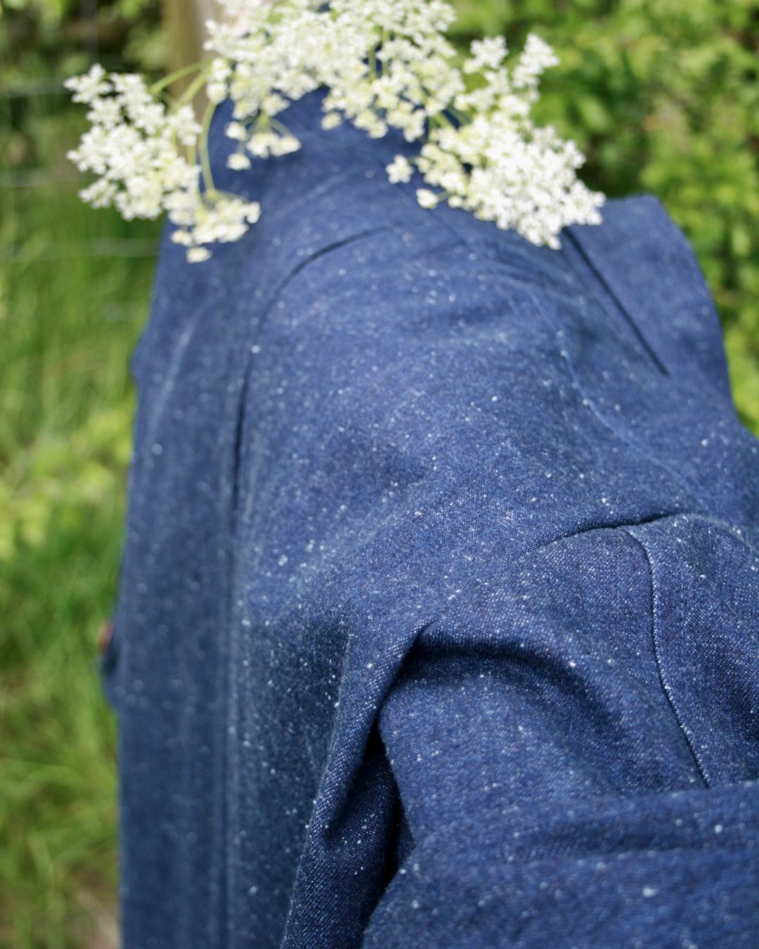 close up image of denim jacket with slubby texture