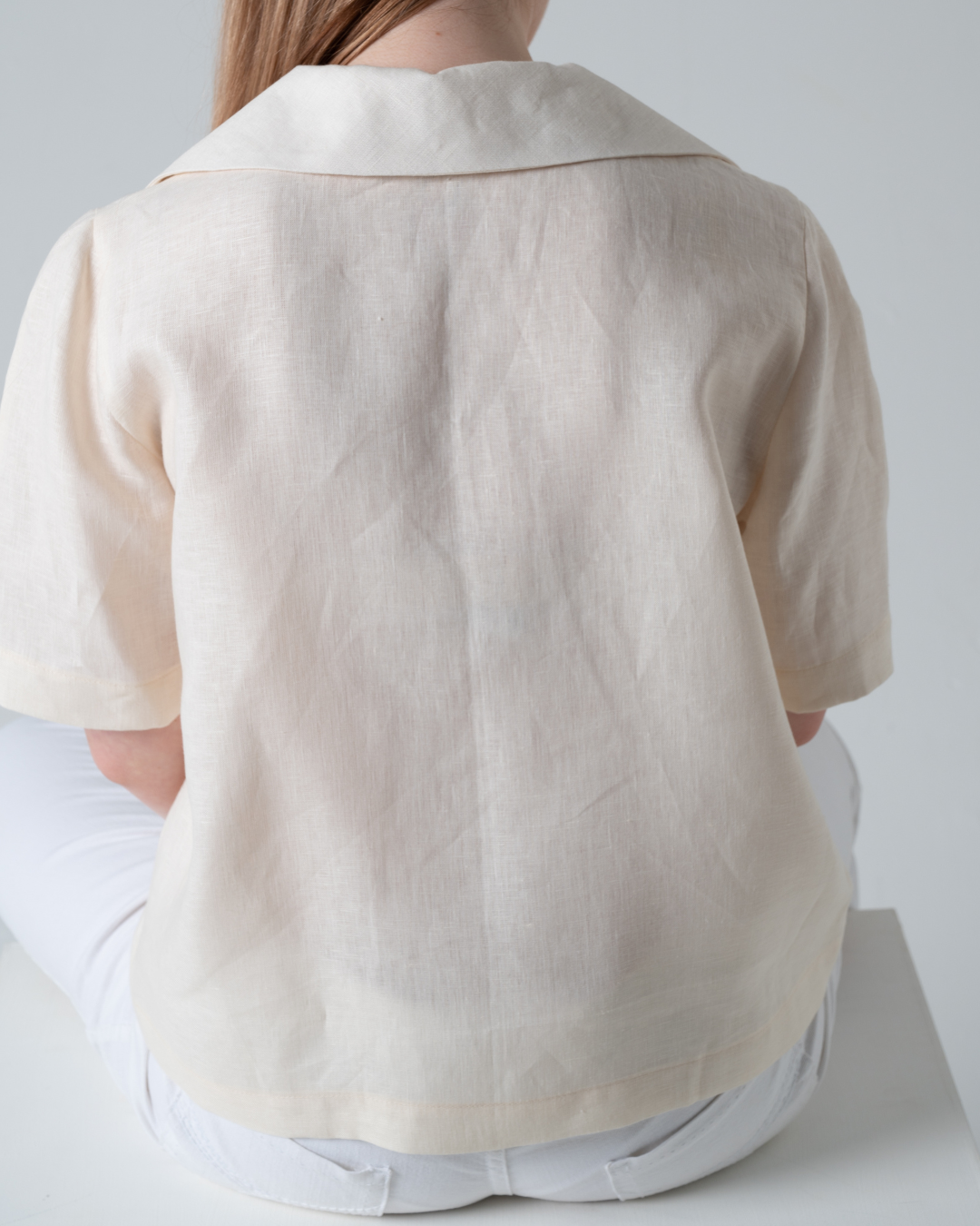 short sleeve linen blouse with revere collar in cream, back view