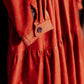 orange cordoroy dress detail showing cuff with floral trim.