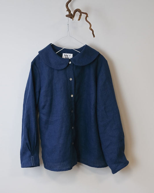 Blue shirt with a collar on a hanger against a white background