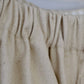 Close-up of beige textured fabric with a blurred background