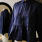 Navy blue shirt on a mannequin with a blurred background
