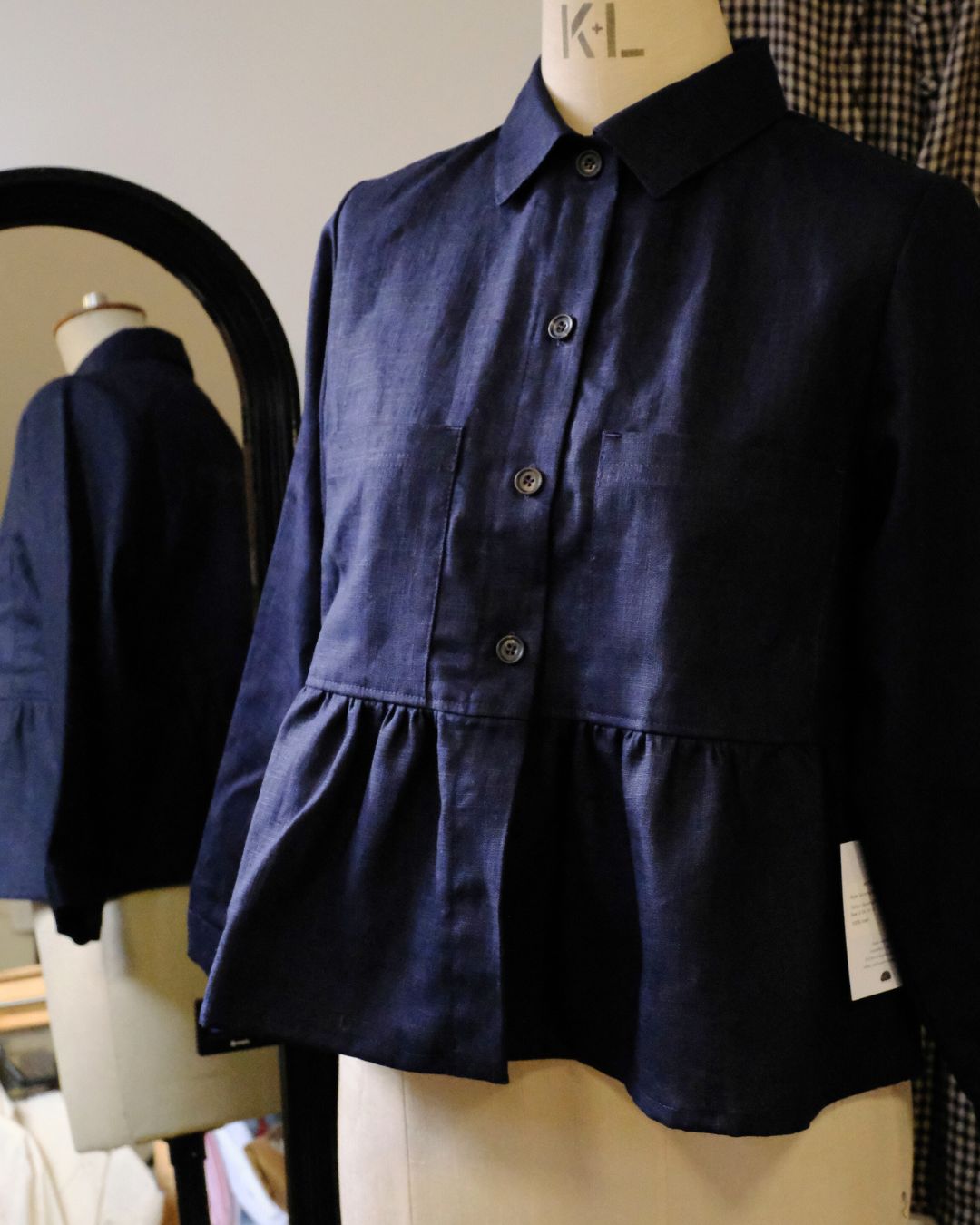 Navy blue shirt on a mannequin with a blurred background