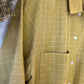 Close-up of a mustard yellow checkered shirt with a blurred background