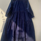 Navy blue dress with a layered skirt on a white background