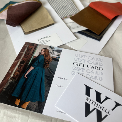 Gift card with some fabric swatches on a cream background