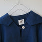 Blue shirt with a brand label on a hanger against a white background