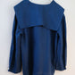 Blue top with a unique design on a white background