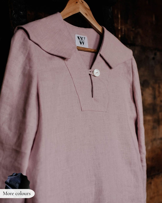 Pink coat on a hanger with a blurred background
