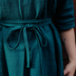 close up of teal blue dress fabric with tied waist.