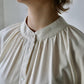 close up detail of rounded collar on white blouse