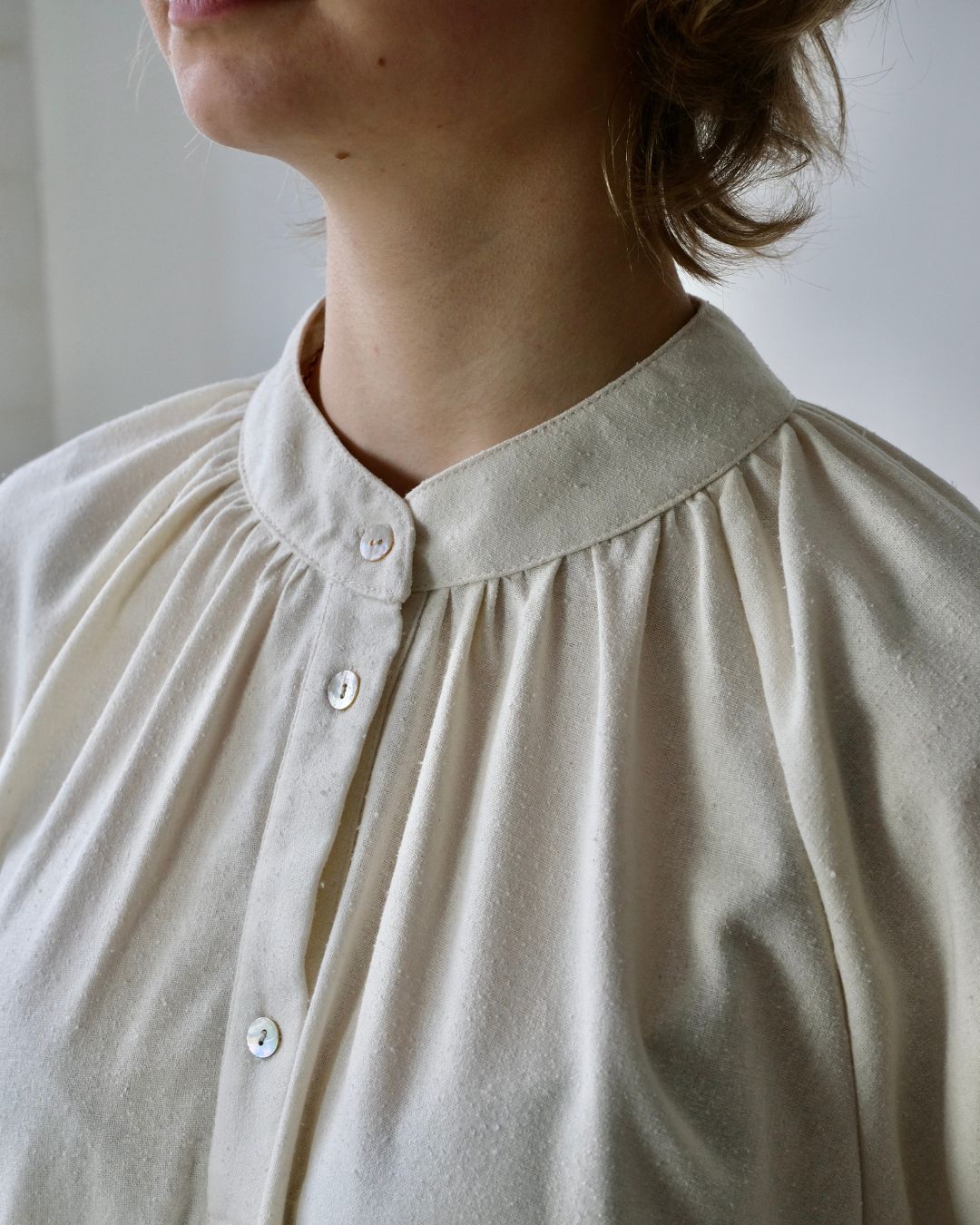 close up detail of rounded collar on white blouse