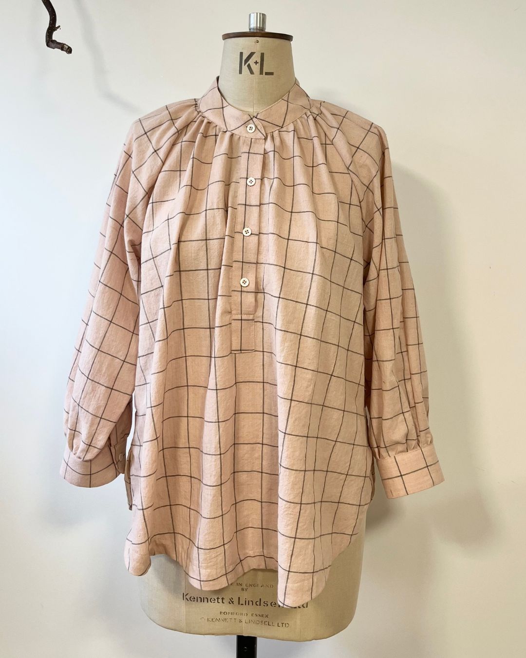 Plaid shirt on a mannequin with a white background