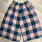 Plaid shorts with pink and blue pattern on a wooden floor
