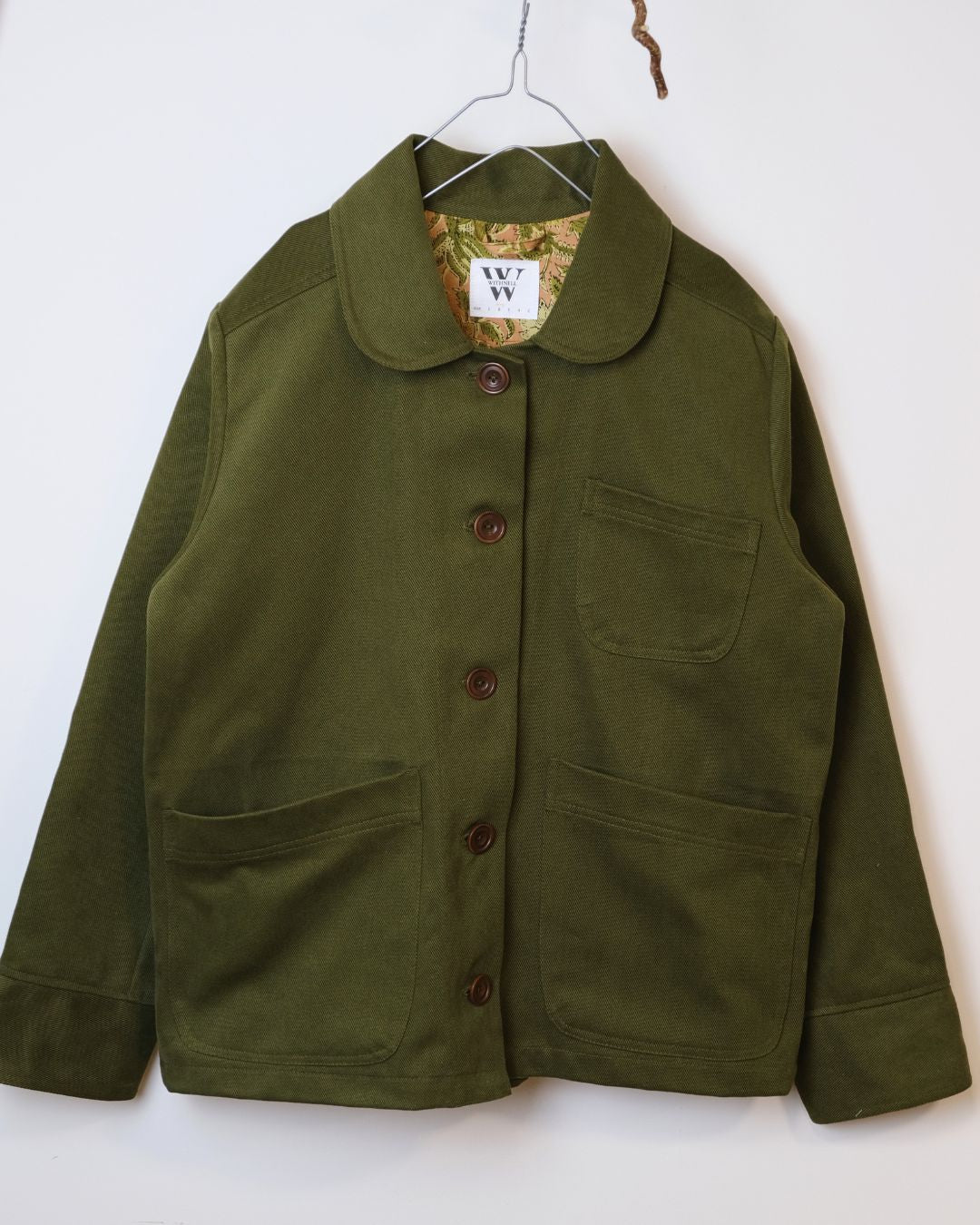 Green jacket against white background