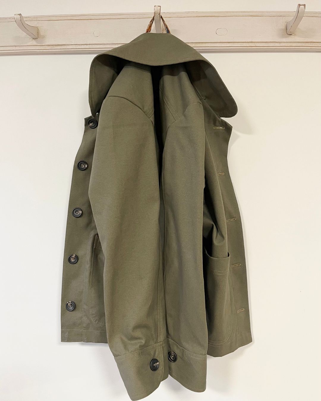 Green jacket with buttons on a white background