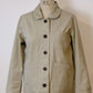 Beige jacket on a mannequin with 'K.L' branding against a white background