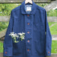 denim jacket hanging from gate.