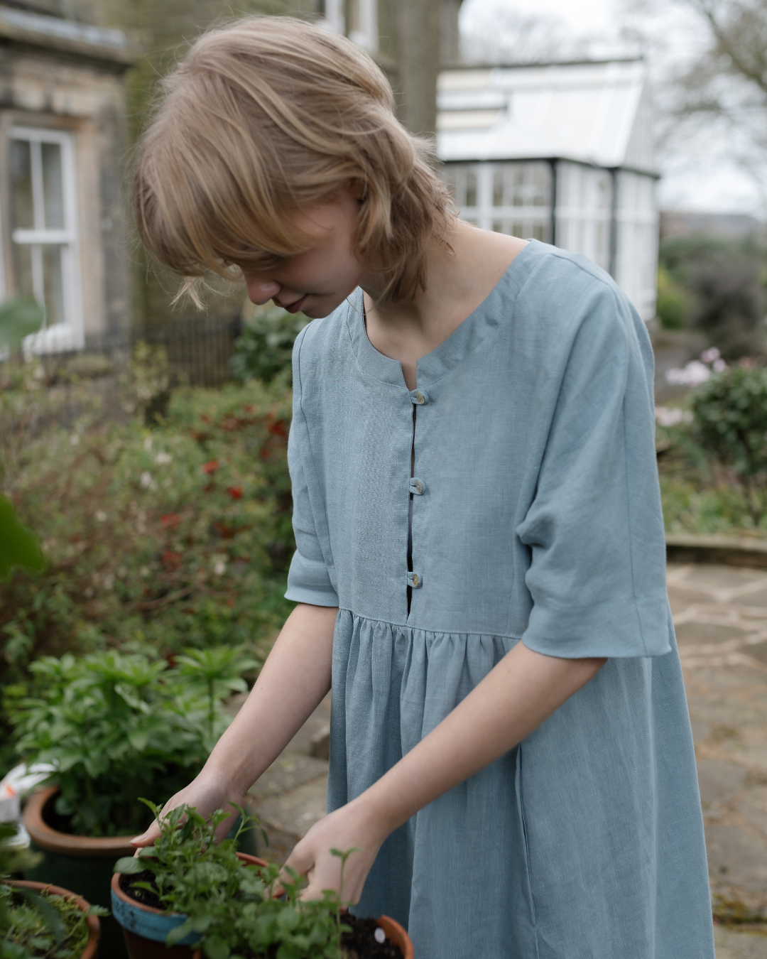 woman gardening  with house in background