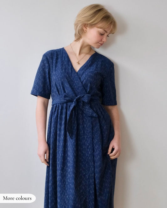 Woman wearing a blue dress against a plain background