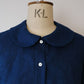 Navy blue shirt on a mannequin with 'K+L' branding.