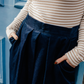 close up detail of cord culottes showing flat waistband and pleats.