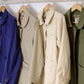 Four jackets hanging on a rack with visible brand labels.