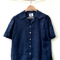 indigo linen blouse on coat hanger, hanging from a rope